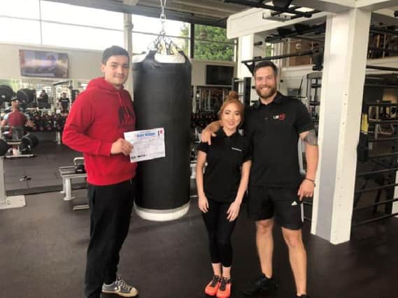 Henry Watkins with Lifestyle Fitness manager, Katie Pettitt, and personal trainer, Liam Gudgeon.