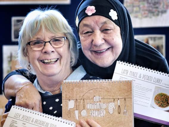 Jean Duff and Sameena Khan show some of their recipes in the Our Community Recipes book which was launched at the event.