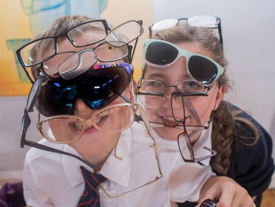 Year Six pupils Lydia Uttley and Theo Ford model a selection of the spectacles donated for the Vision Aid appeal at St Augustine's RC Primary School in Burnley.