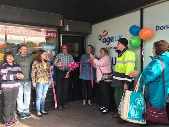 The Age UK team opening up the shop to customers after refurbishment. (s)