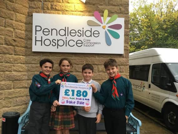 Maisey and Ruairi Dillon (11) and Brodie (nine) and Noah McKane (11)  with the cheque for the money they raised for Pendleside Hospice