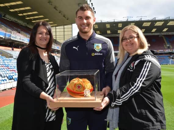 Sam Vokes received his special memento from FAW representatives Lucy Mason, right, and Lianne Cole.