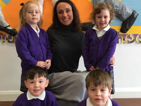 Reception teacher and Deputy Head at Laneshaw Bridge, Gaynor Canty, with some of the school's reception children.
