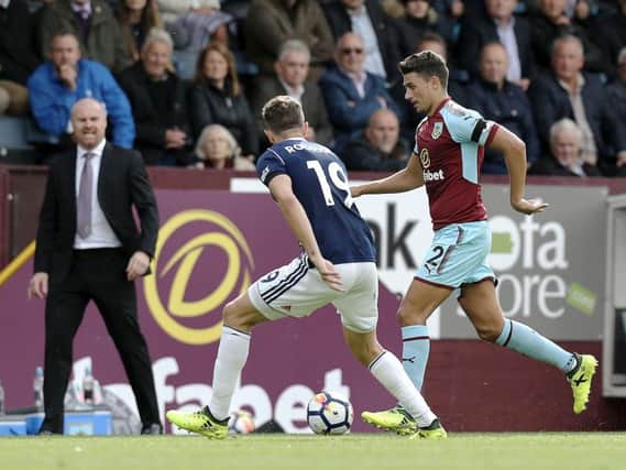 Sean Dyche watches from the sidelines as Matt Lowton takes on Jay Rodriguez