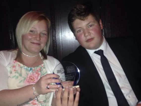 Ben and Charlotte with their trophy for winning the bravery award at the 2BR Local Hero Awards.