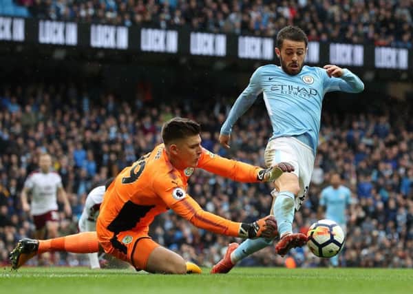 Manchester City's Bernardo Silva (right) is felled by Burnley goalkeeper Nick Pope resulting in a penalty during the Premier League match at the Etihad Stadium, Manchester. PRESS ASSOCIATION Photo. Picture date: Saturday October 21, 2017. See PA story SOCCER Man City. Photo credit should read: Martin Rickett/PA Wire. RESTRICTIONS: EDITORIAL USE ONLY No use with unauthorised audio, video, data, fixture lists, club/league logos or "live" services. Online in-match use limited to 75 images, no video emulation. No use in betting, games or single club/league/player publications.