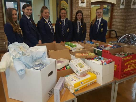 Pupils at Blessed Trinity RC College in Burnley with some of the items they donated to Safenet