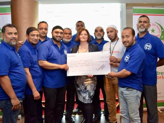 The Burnley Generous Hands group and Burnley MP Julie Cooper with a cheque for 7,937 to be presented to the Muslim Charity (s)