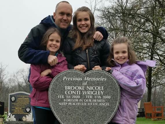 Martin Wrigley and daughters Ellyse, Evie and Halli at Brooke's gravestone. (s)
