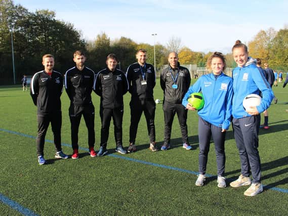Football stars Naomi (right) and Sadie with the Academy staff