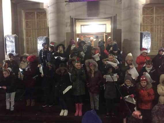 Padiham schoolchildren prepare to sing to to the crowds at the town's annual Christmas lights switch on.
