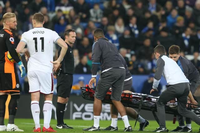 Clarets winger Robbie Brady is stretchered off after a collision with Leicester City defender Harry Maguire