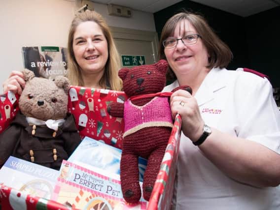 Jane Harrison of Lloyds Bank (left) hands over the latest collection of donated toys for the Burnley Express and Salvation Army Christmas Toy Appeal to Capt Maisie Veacock.