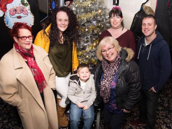 Lucas is pictured with (from left to right) his grandma Celia, mum Jenna, Burnley Express reporter Sue Plunkett and Leanne and Adi from the Coal Clough pub.