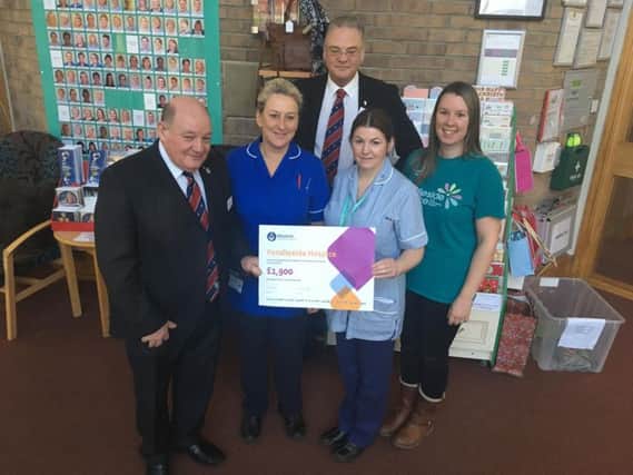 Members of the Burnley and Pendle Freemasons make their donation to Pendleside Hospice.