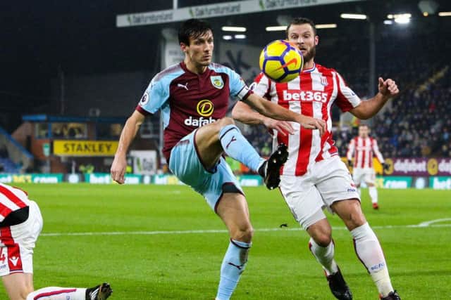 Jack Cork holds off the challenge from Stoke City's Erik Pieters