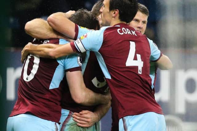 Burnley players help Ashley Barnes celebrate his late winner against Stoke on Tuesday night