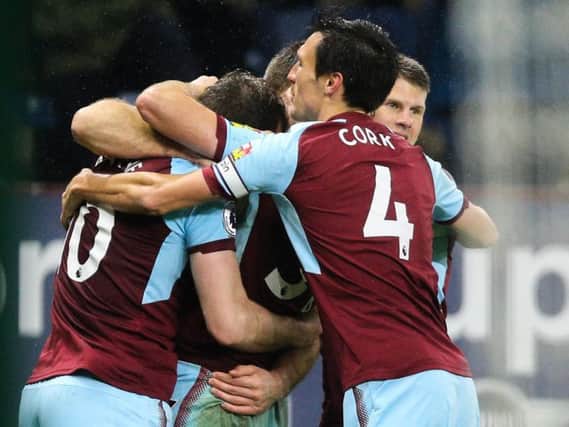 Burnley players help Ashley Barnes celebrate his late winner against Stoke on Tuesday night