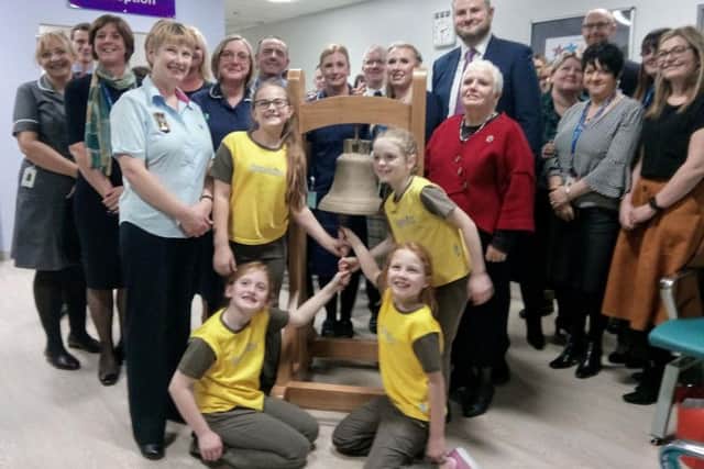 Brownies from Accrington ring the old Burnley Workhouse bell to signal the opening of the new chemo unit
