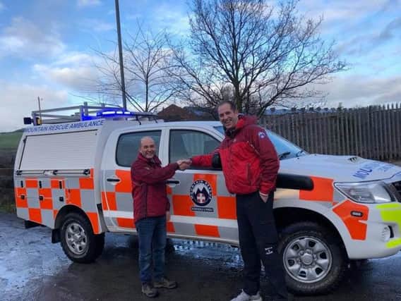 Deputy Team Leader for CBMRT David Cross receives the vehicle from Andy Bradshaw at RMRT