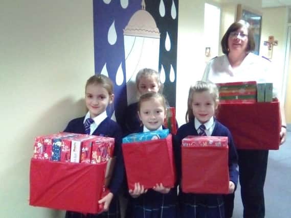 Pupils at St Mary Magdalene's RC Primary School in Burnley hand over gifts to Captain Maisie Veacock for the Salvation Army and Burnley Express Christmas Toy Appeal.
