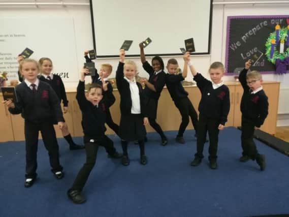 Pupils from St Augustine's RC Primary School in Burnley with their passports to success as part of the Children's University scheme.