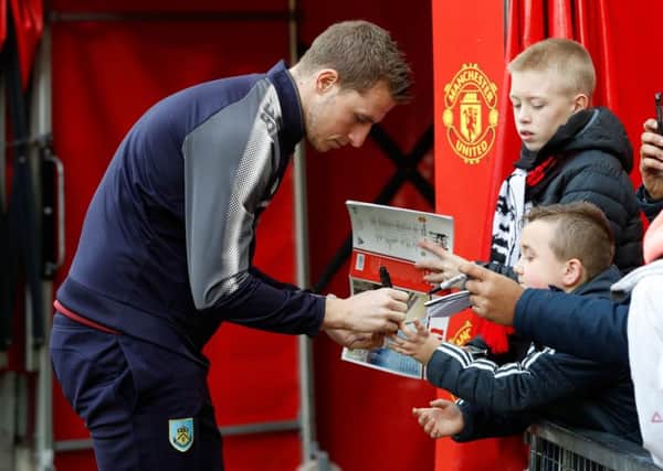 Burnley's Chris Wood signing autographs before the Premier League match at Old Trafford, Manchester. PRESS ASSOCIATION Photo. Picture date: Tuesday December 26, 2017. See PA story SOCCER Man Utd. Photo credit should read: Martin Rickett/PA Wire. RESTRICTIONS: EDITORIAL USE ONLY No use with unauthorised audio, video, data, fixture lists, club/league logos or "live" services. Online in-match use limited to 75 images, no video emulation. No use in betting, games or single club/league/player publications.