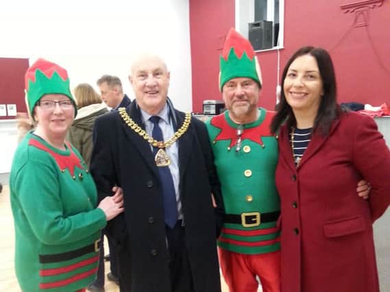 Two elves welcome the Mayor and Mayoress of Burnley to the annual Ightenhill Carols in Park event.