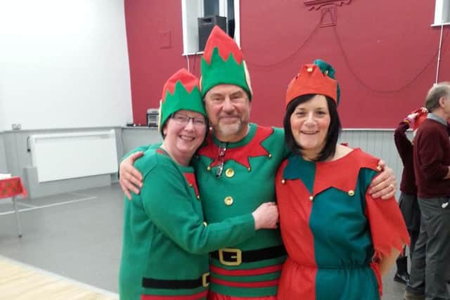 A trio of elves prepare to greet guests to the annual Ightenhill Carols in the Park event in Burnley.