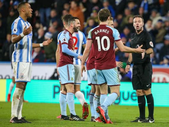 Referee Paul Tierney waves away Burnley appeals for a penalty