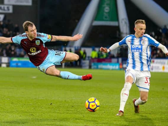 Huddersfield Town's Florent Hadergjonaj attempts to block the shot from Burnley's Ashley Barnes