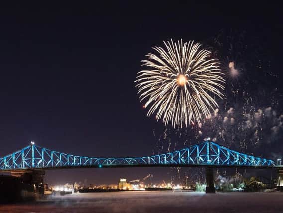 Fireworks explode over the Jacques Cartier bridge during New Years Eve celebrations in Montreal