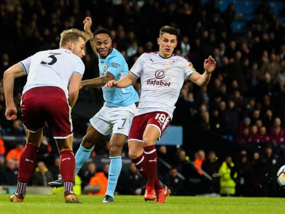 Manchester City's Raheem Sterling takes on Burnley's Charlie Taylor and Ashley Westwood