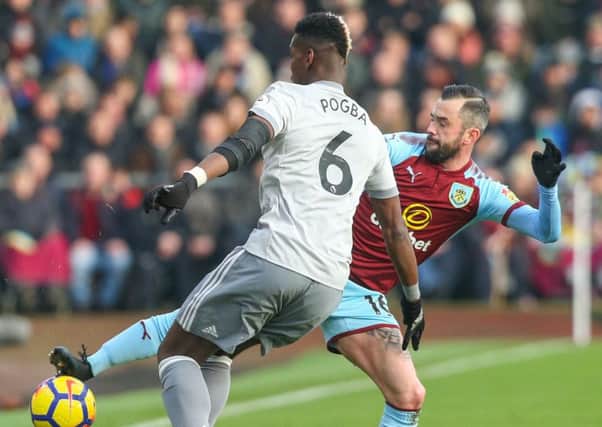Steven Defour battles with Manchester United's Paul Pogba