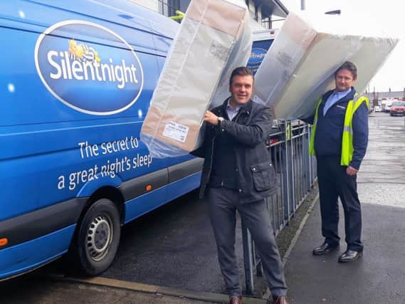 Robert Livingstone (front) who is logistics director at Silentnight, loads mattresses to be delivered to the Recycling Lives charity with his colleague Andy Swift.