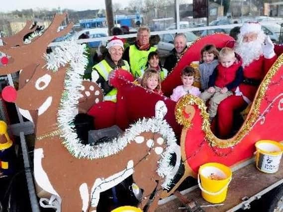 Father Christmas parks his sleigh to greet youngsters at the Padiham Tesco store in previous Santa Sleigh event organised by Padiham Rotary Club.