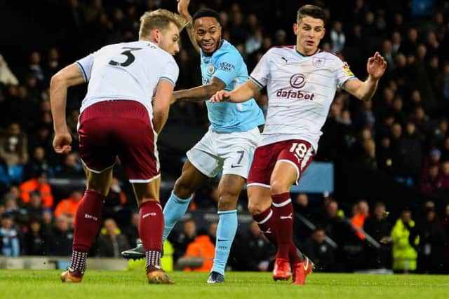 Manchester City's Raheem Sterling takes on Burnley's Charlie Taylor and Ashley Westwood.
