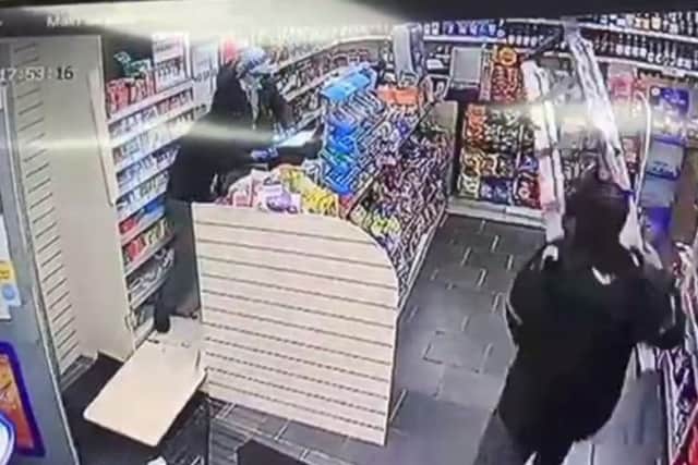 The store worker fends off the raiders with step ladders