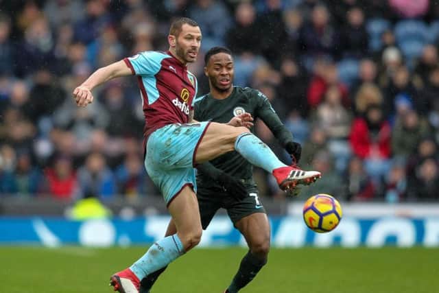 Phil Bardsley takes the ball off Man City winger Raheem Sterling