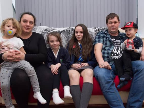 Carl and Manjit Priestley, who lose everything when a faulty tumble dryer caused a fire at their home, with their children, Gillian (13) Libby (right) Lewis (four) and three-year-old Darcy.