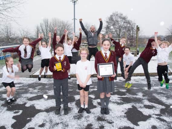 Wellfield Primary School pupils and teacher Mr Andrew Peyton are jumping for joy after being presented with a prestigous sports award