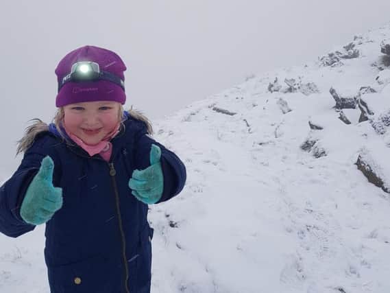 Dynamic Daisy Hooper (four) gives the thumbs up to her challenge to conquer Pendle Hill 52 times this year.