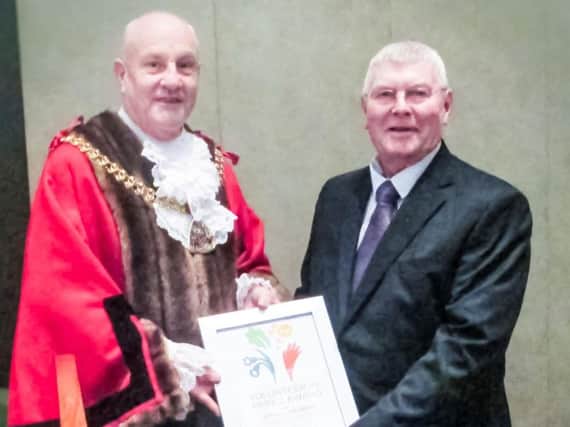Steven receiving his award from Mayor of Burnley Coun. Howard Baker