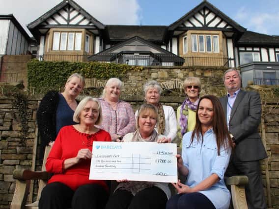 The eight carers who were treated to lunch at the Higher Trapp  Hotel in Simonstone with the cheque they received from the hotel and John Rattigan who is the chief executive officer of Crossroads Care East Lancashire