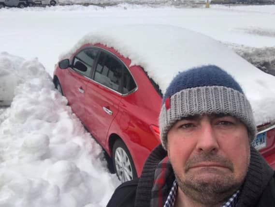 Reel Cinema manager Andy White with his hire car in Connecticut, America, where he is stuck after heavy snow fell.