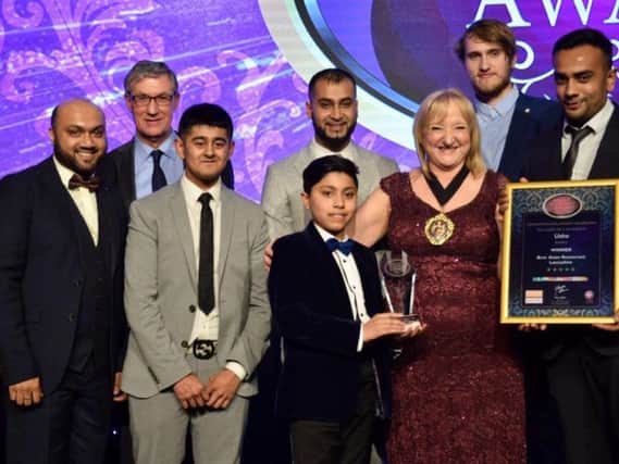 The Usha team collect their 'Best Restaurant in Lancashire' award