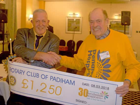 Brian Hough from Pendleside receives a cheque from president David Alexander of Rotary Club of Padiham