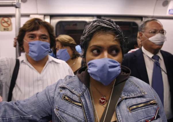 Commuters wear masks as a precaution against infection inside a subway in Mexico City, in April 2009, after swine flu claimed the lives of 60 people