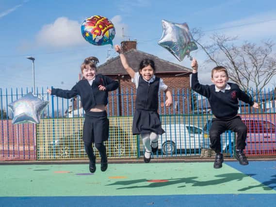 Leah Carrington, Jasmine Majed and Rory Wilcock  are jumping for joy the the good Ofsted report their school, St Augustine's RC Primary in Burnley, has received.