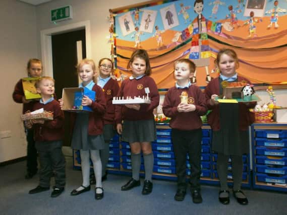 Some of the students at Burnley's Holy Trinity Primary School show off their animal themed painted egg creations